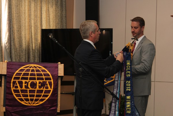 Carpenter (l) and Samuel Milford, vice president for programs, added recently received award streamers to the chapter flag in August. The awards included: the Brenda M. Dougherty Diversity Award (first time ever received by an overseas chapter), a Model Chapter Award, and two Albert J. Myer Awards, one for Member Retention and one for Achievement.